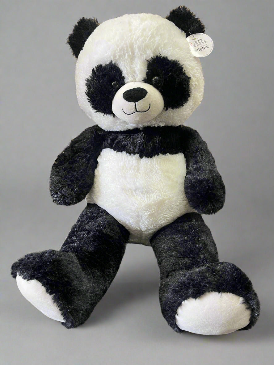 Plush panda toy on a textured surface