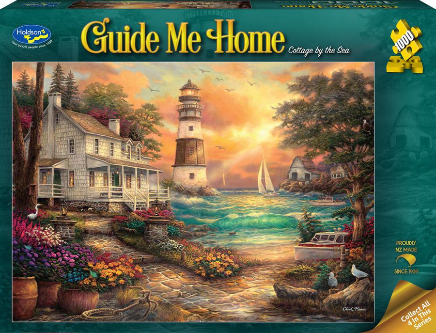 1000 Jigsaw puzzle box titled 'Guide Me Home: Cottage by the Sea' with a lighthouse and coastal scene.