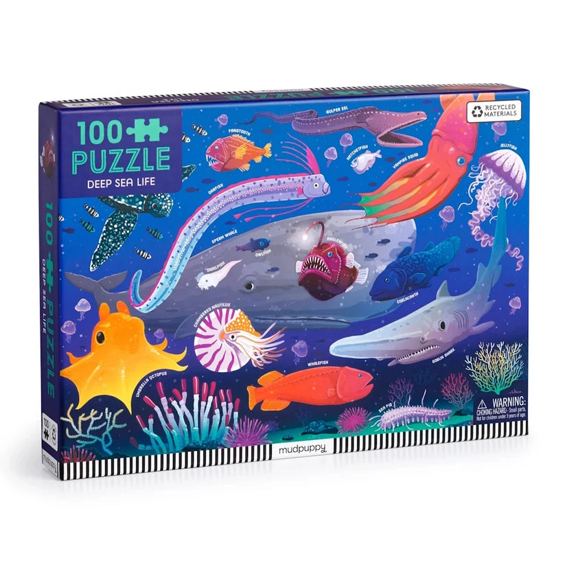 Jigsaw puzzle box featuring deep sea life illustrations on a blue background