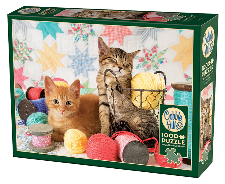 Cobble Hill puzzle box with two cats and yarn balls on a colorful background balls of fluff