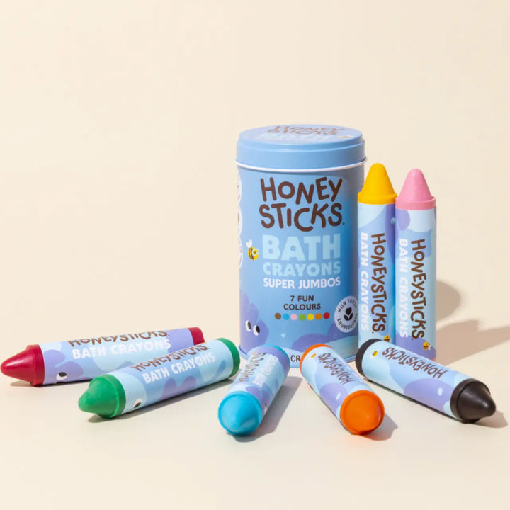 Honey Sticks bath crayons with a tin on a beige background