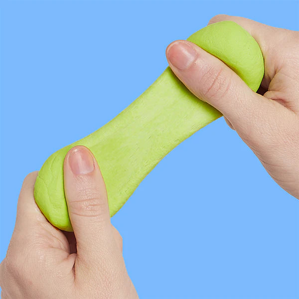 Green stress ball being held between two hands against a blue background