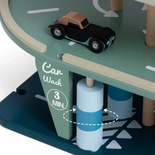 Toy car wash station with toy truck and labeled car wash area on a green surface.