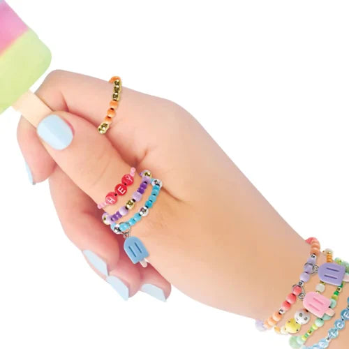 Hand wearing multiple colorful beaded bracelets on a white background