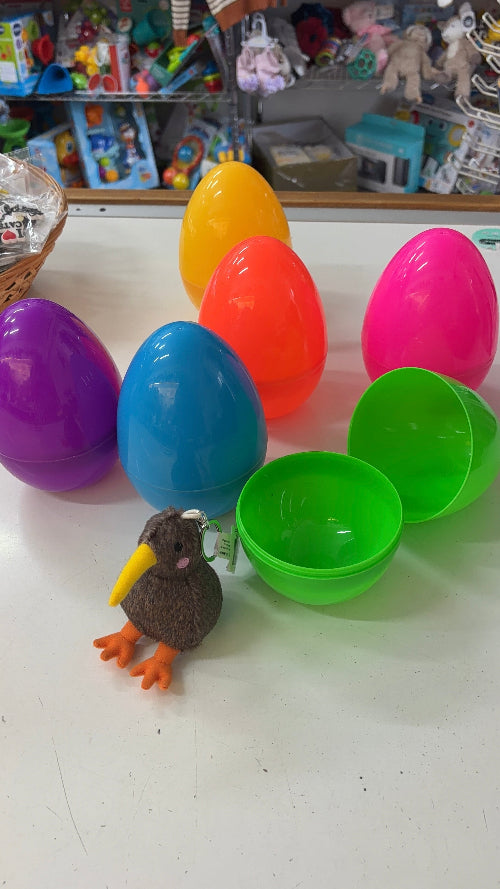 Colorful plastic eggs with a small toy duck on a white surface