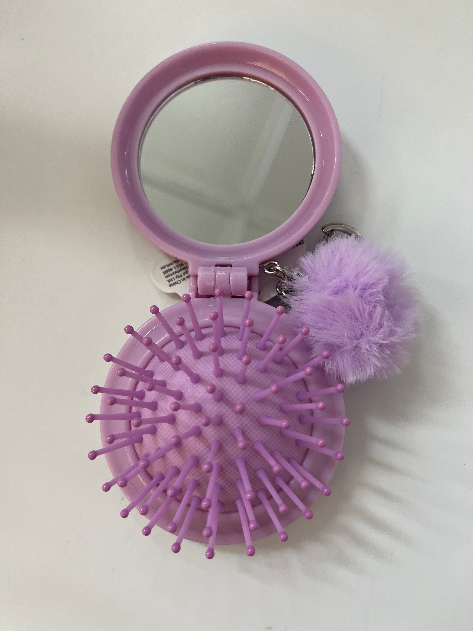 purple hairbrush and compact