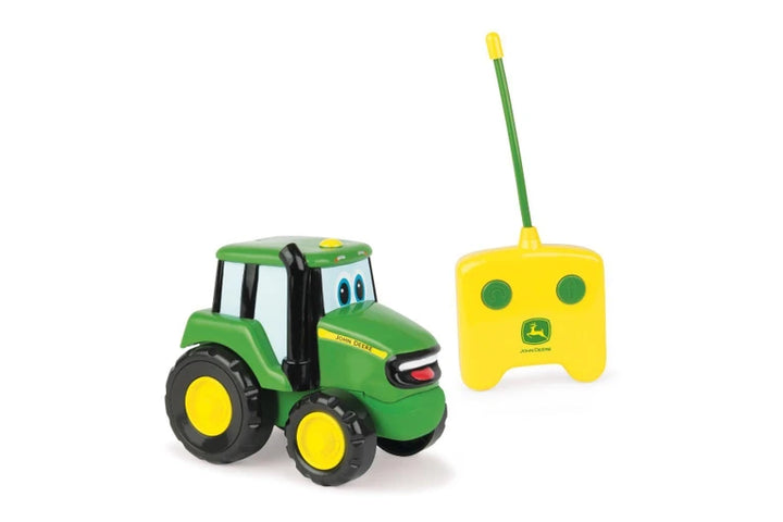 John Deere Johnny Tractor RC with a remote control on a white background