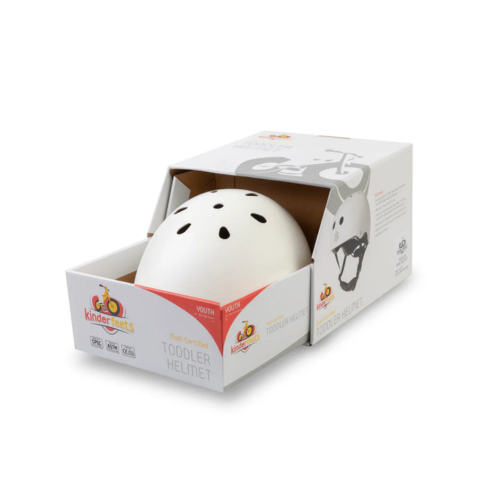 White toddler helmet in a Kinderkross packaging box on a white background