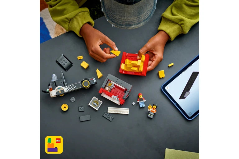Children playing with LEGO bricks on a table with a tablet displaying the LEGO app.