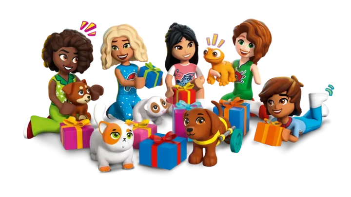 Toy mini figures of children and animals with presents on a white background