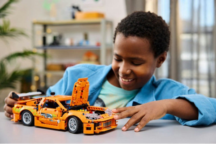 child playing with LEGO Technic Fast & Furious Toyota Supra MK4 42204