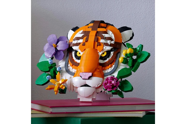 Colorful tiger head model with flowers on a gray background
