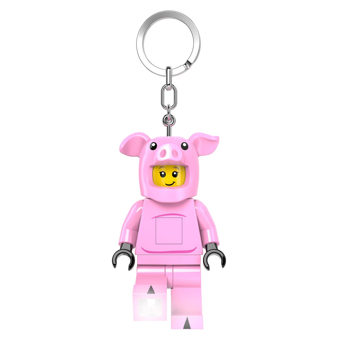 Keychain in the shape of a LEGO figure minifigure wearing a pink pig costume on a white background