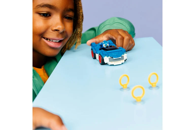 Child playing with a toy car on a table