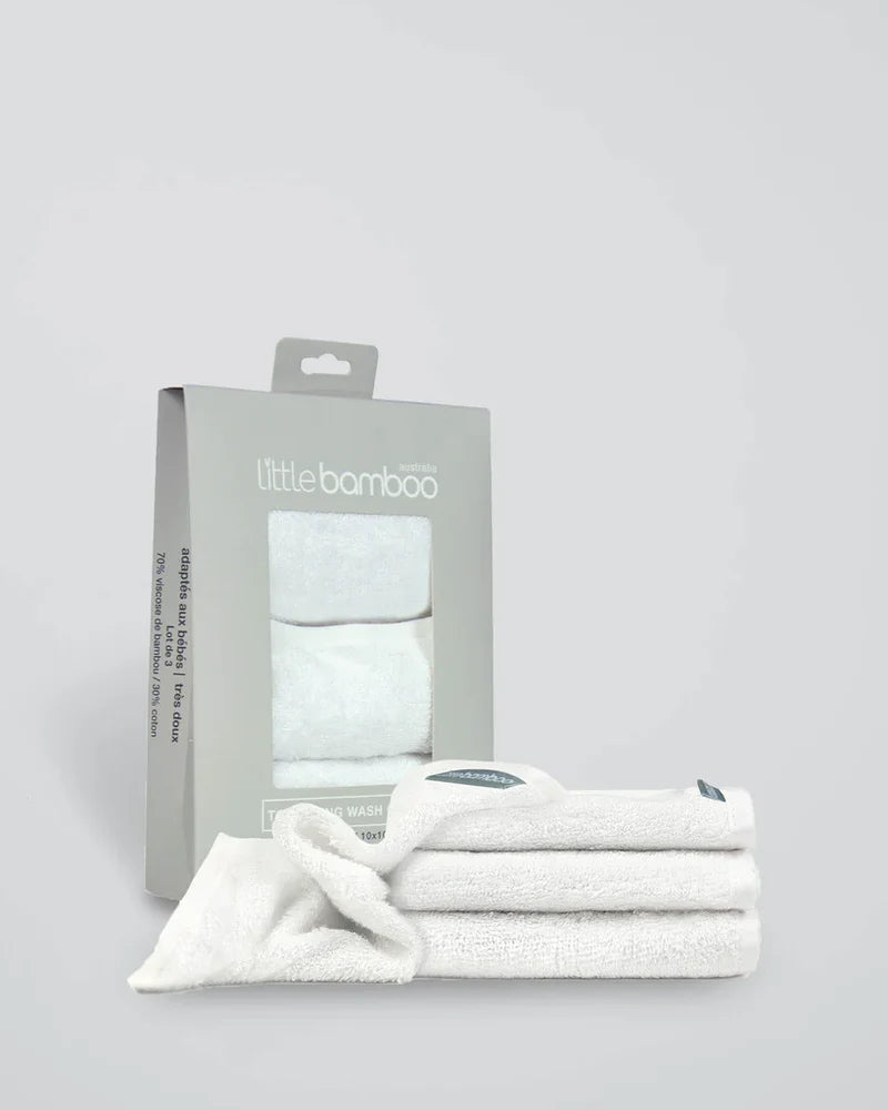 White bamboo washcloth with packaging on a light gray background