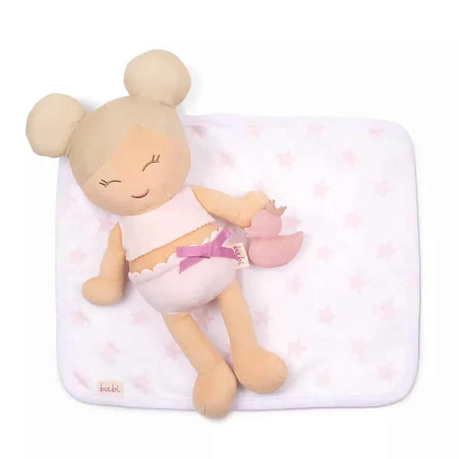 bath  Plush doll with blonde hair and a pink outfit on a white blanket