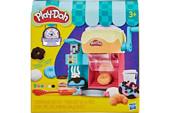 Play-Doh Compound Cookie Dough Playset in its original retail packaging, featuring a play dough mixer with a yellow and blue awning, colorful play dough balls, and various cookie and donut accessories.