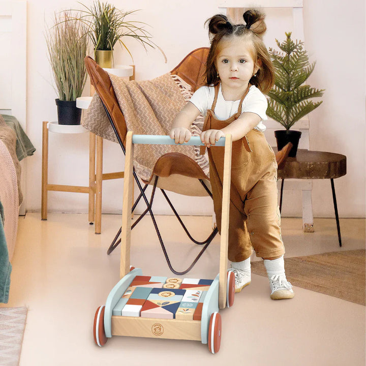 Child playing with a wooden walker with blocks toy in a home setting