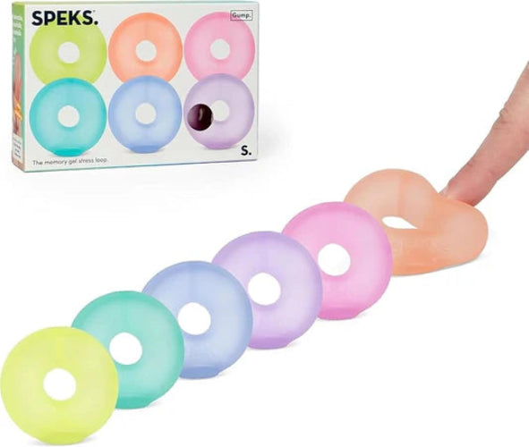 Set of pastel-colored donut-shaped gel stress balls with Speks packaging in the background.