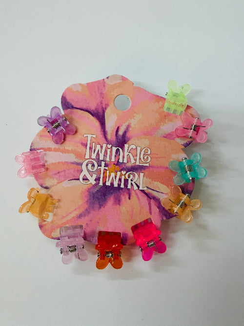 Colorful hair clips on a 'Twinkle & Twirl' branded card with a tie-dye design.