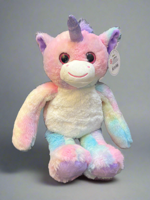 Pastel-colored unicorn plush toy with a tag on a gray background
