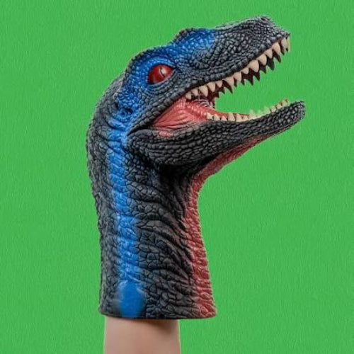 A blue and black textured dinosaur hand puppet with an open mouth, red eye, and pink interior, worn on a hand against a solid green background.