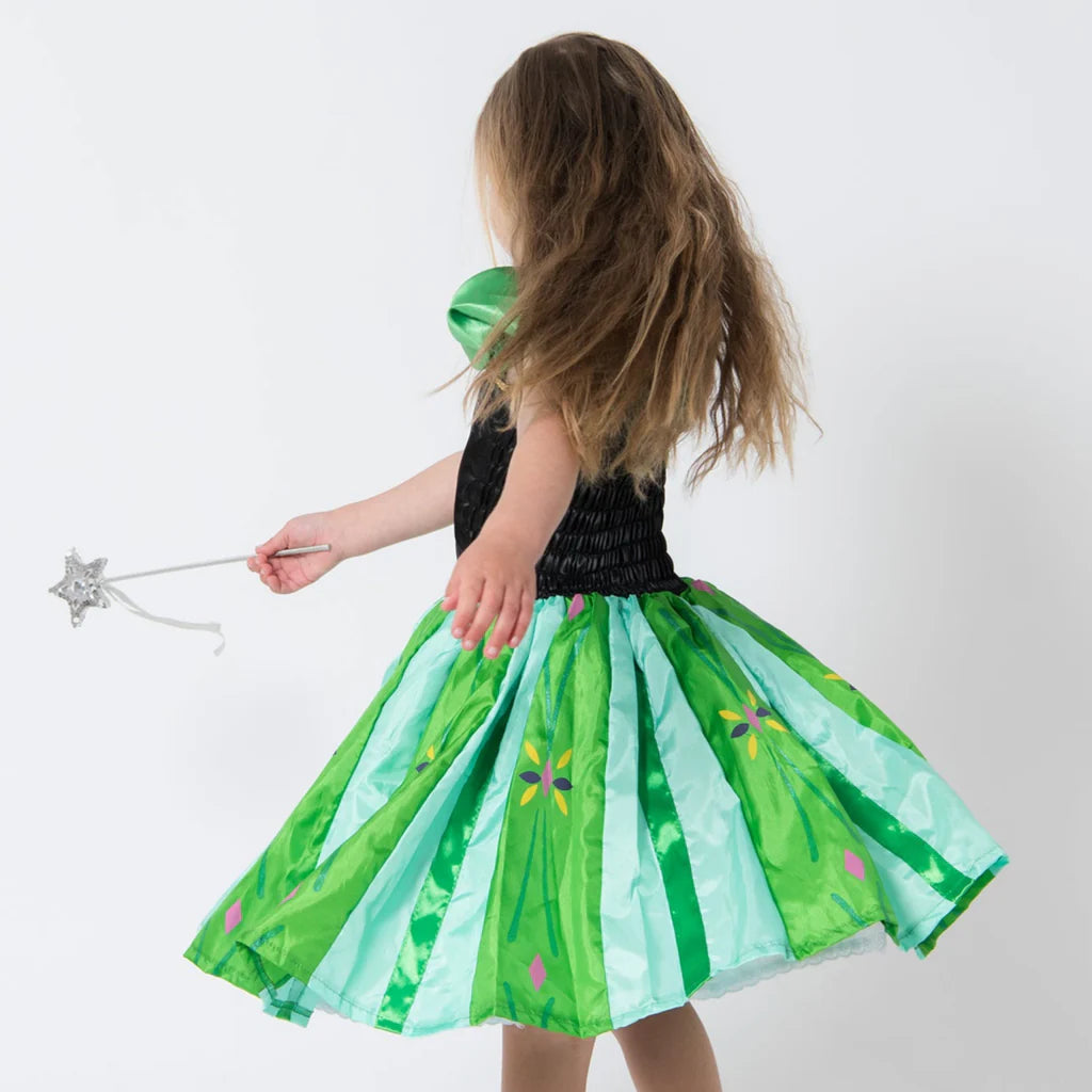 Child wearing a green and black dress with a fairy wand on a white background