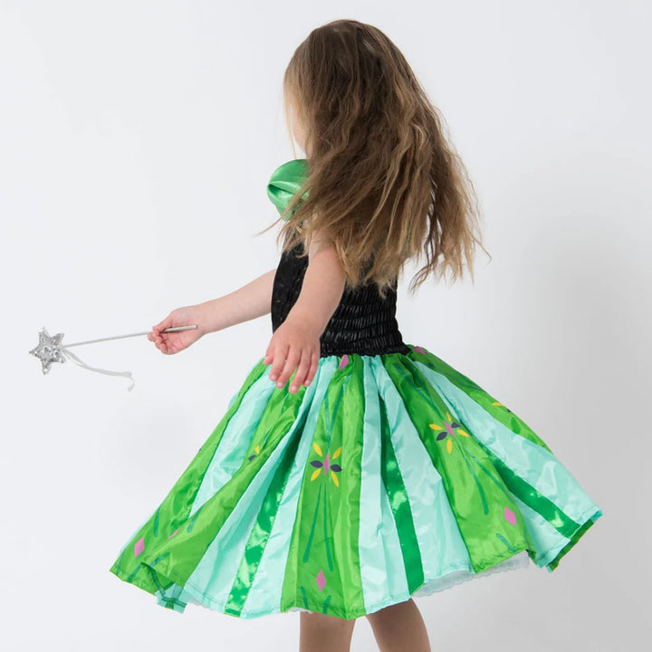 Child wearing a green and black dress with a fairy wand on a white background