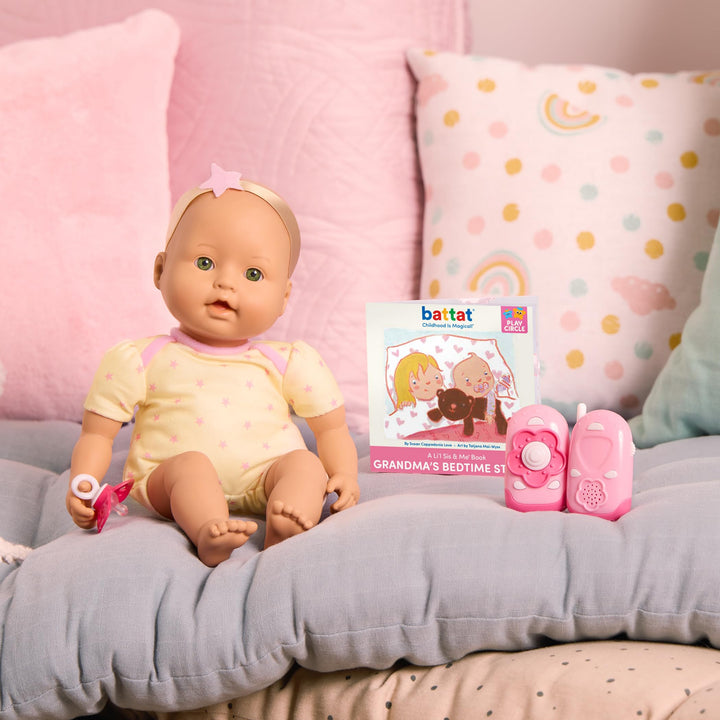 Newborn Baby doll with a book and toys on a couch