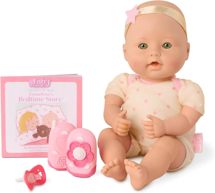 Baby doll with accessories including a book and pacifier on a white background