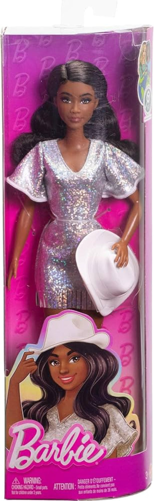 Barbie doll packaging with a doll wearing a silver dress and white hat.