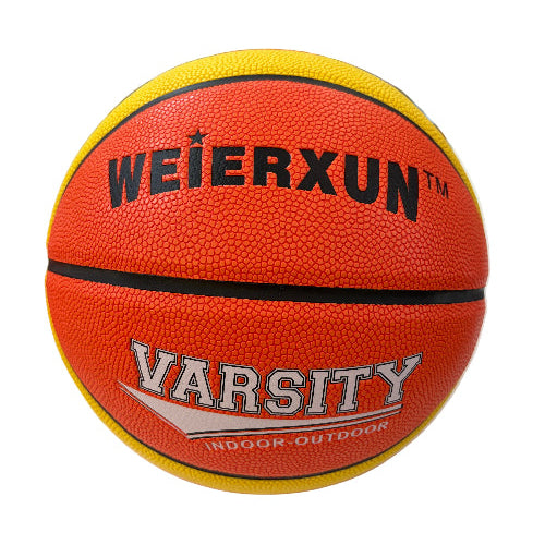 An orange and yellow Weierxun Varsity basketball with black and white lettering, resting on a white surface with a blurred toy store background.