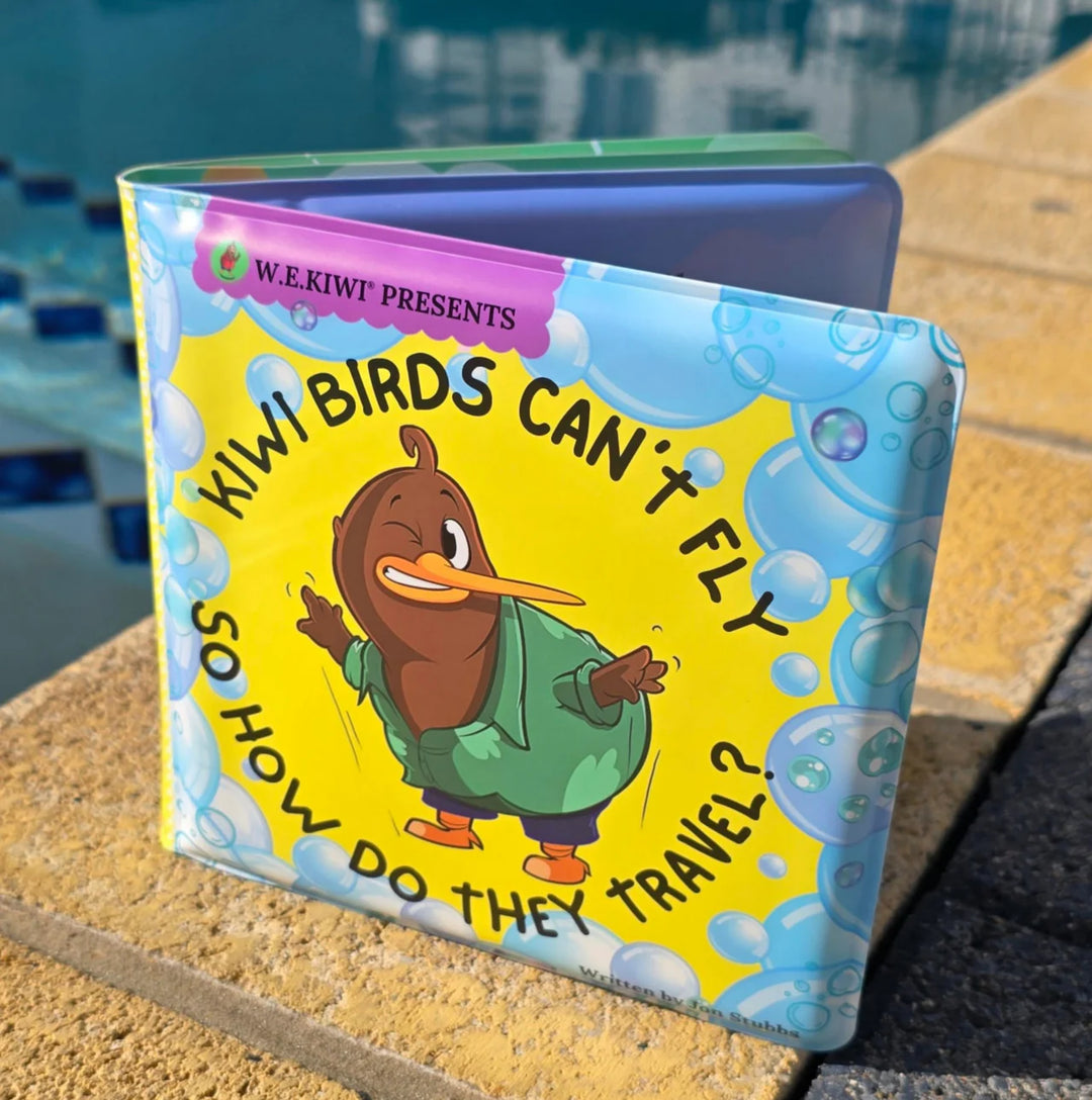 Children's book titled 'Wiwi Birds Can't Fly So How Do They Travel?' by W.E. Kiwi on a surface with a blurred background.