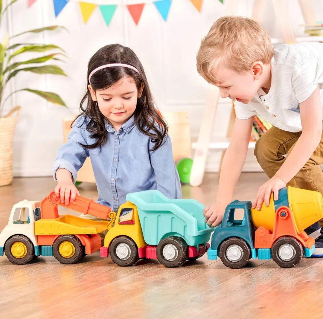 Two children playing with battat wonder wheels trucks
