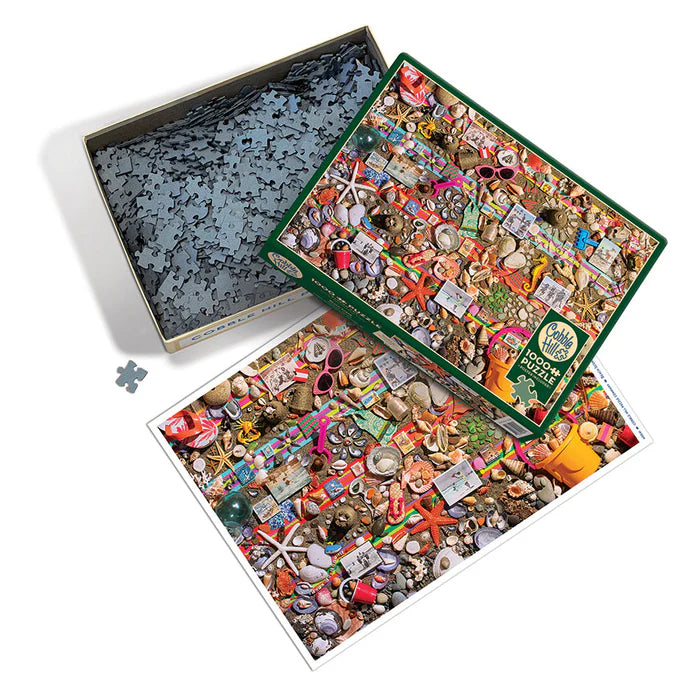 Cobble hill Beach Scene 1000 piece puzzle Jigsaw puzzle with partially completed pieces and a box of unassembled pieces on a white background