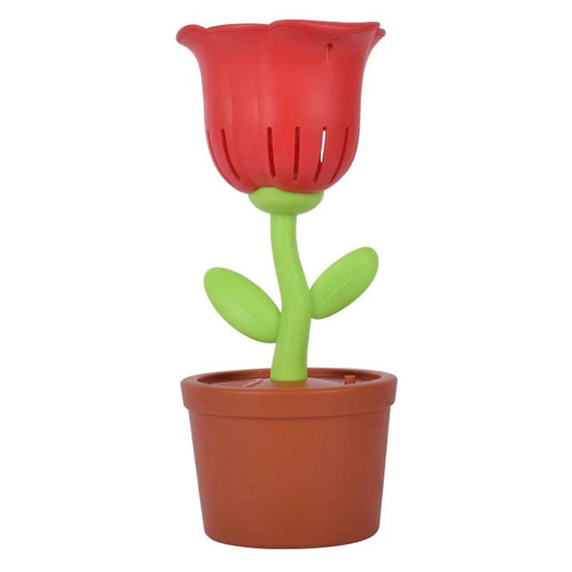 Red flower-shaped lamp with green stem in a terracotta pot on a white background