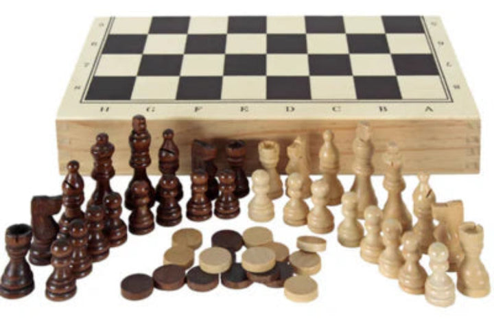 Wooden chess pieces and board on a white background
