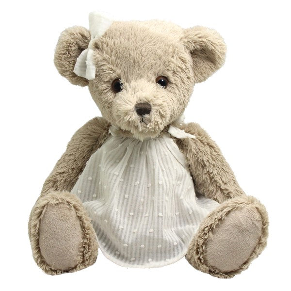 Plush teddy bear wearing a white dress with a bow on a white background