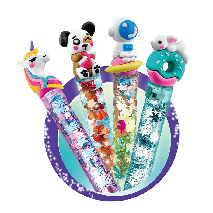 Four novelty gel pens with whimsical character tops, including a unicorn, panda, robot, and donkey, arranged on a circular purple and teal background.