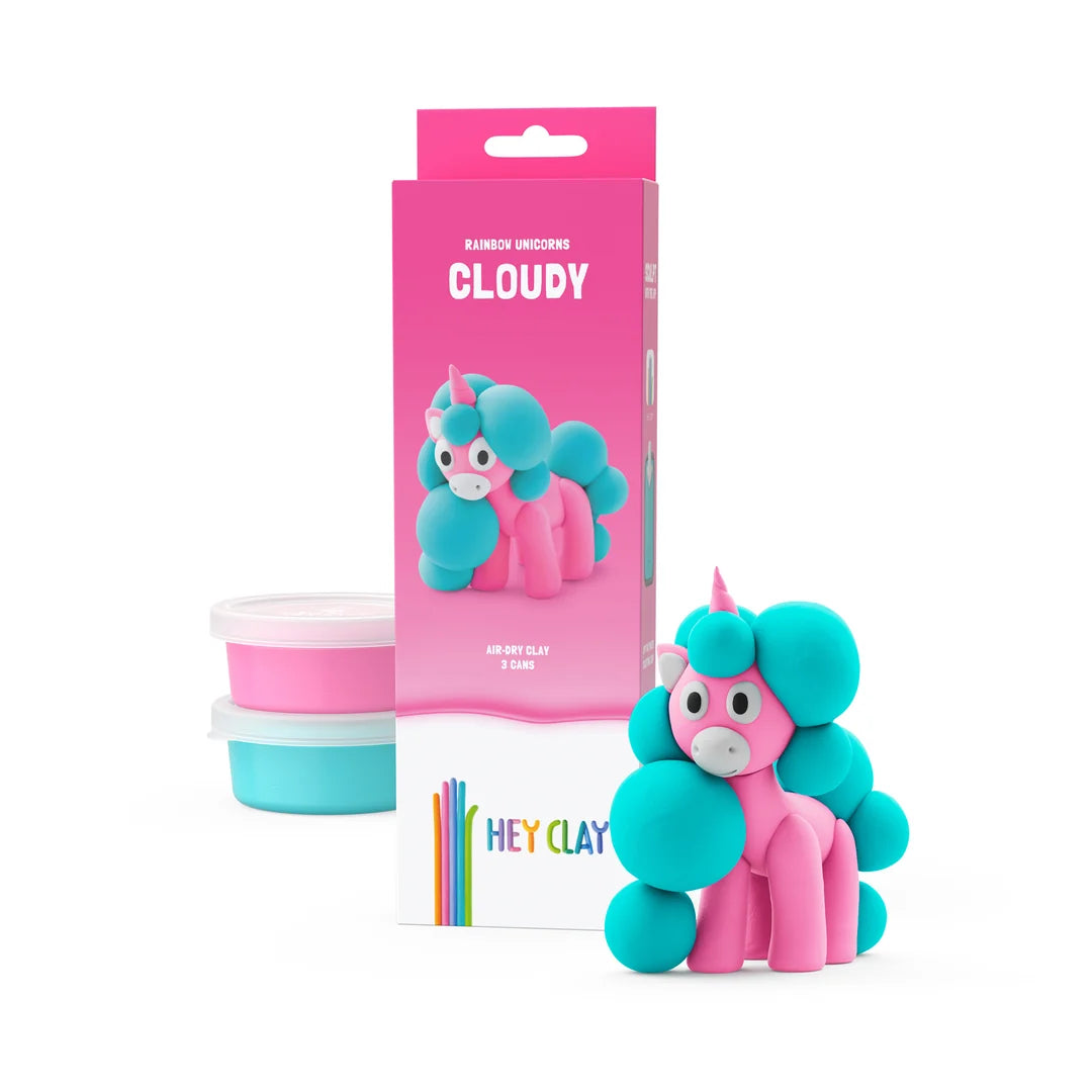 hey clay cloudy unicorn in pink packaging next to hey clay cans and cloud unicorn