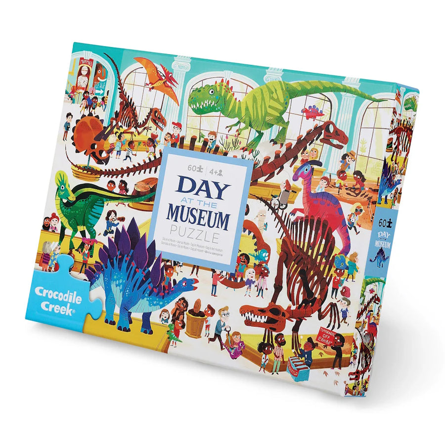 Colorful puzzle 60piece  box with dinosaur illustrations and 'Day at the Museum' text on a white background
