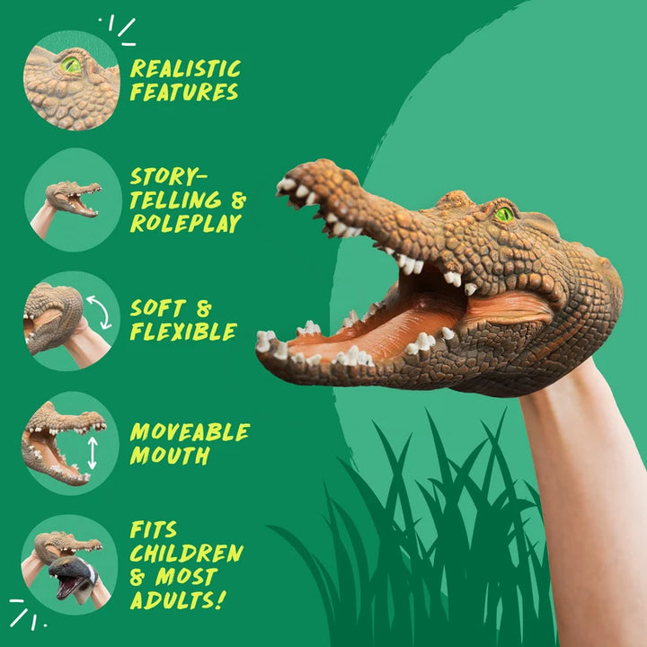 A crocodile or alligator puppet with an open mouth being worn on a person's hand, shown on a green graphic background with feature callouts and text including 'Realistic Features,' 'Story-telling & Roleplay,' 'Soft & Flexible,' 'Moveable Mouth,' and 'Fits Children & Most Adults!'.