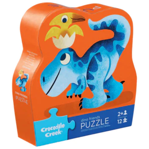 Dinosaur-themed puzzle packaging with a blue dinosaur and yellow chick on an orange background, featuring Crocodile Creek branding.