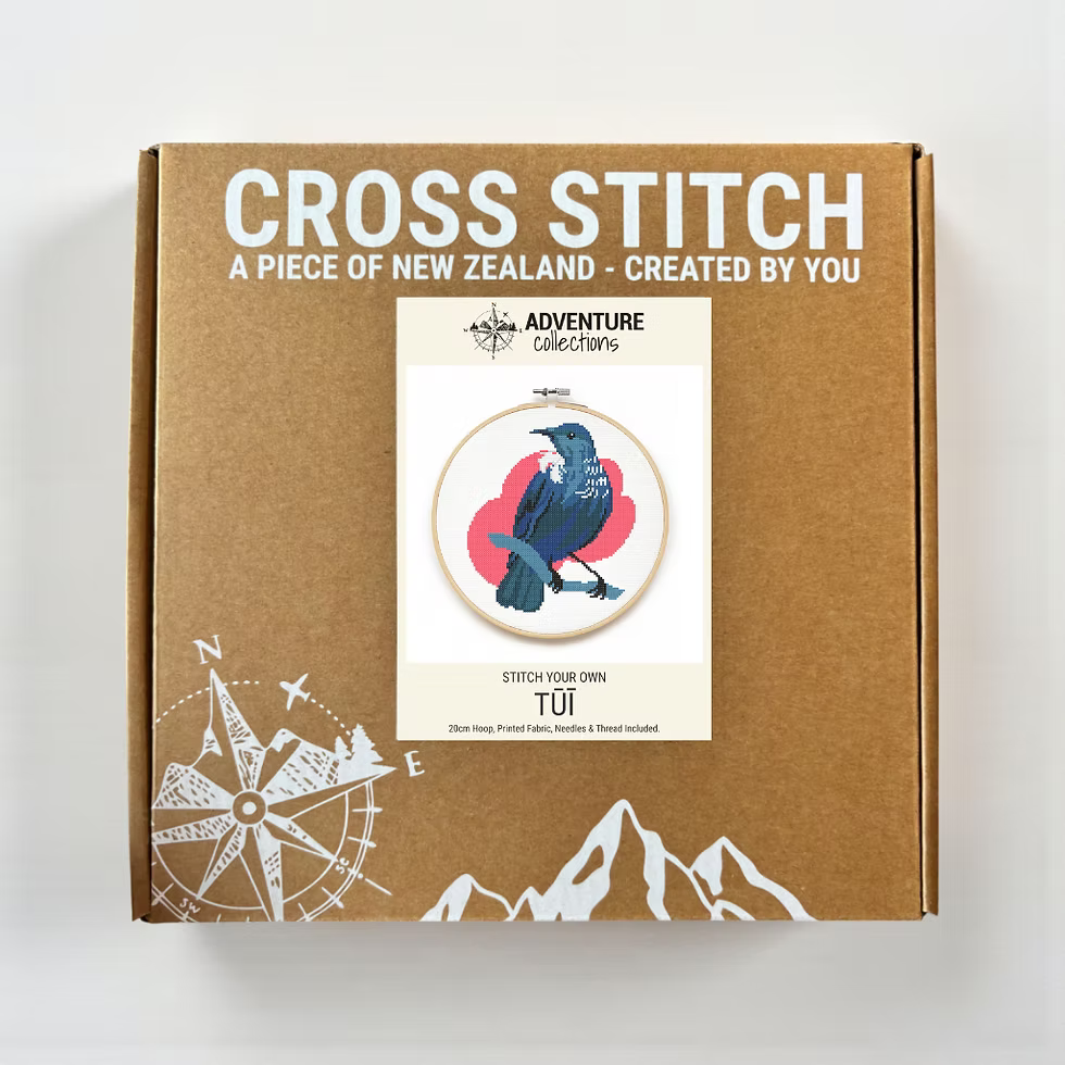 Cross stitch kit packaging with a bird design and text on a white background