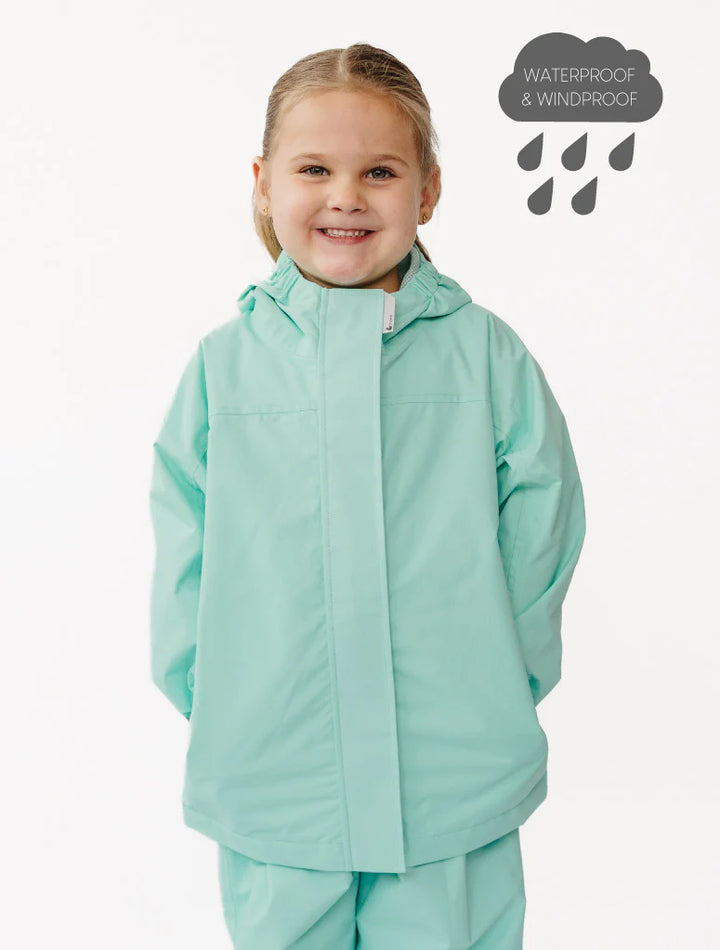 Child wearing a mint green raincoat with waterproof text above on a white background