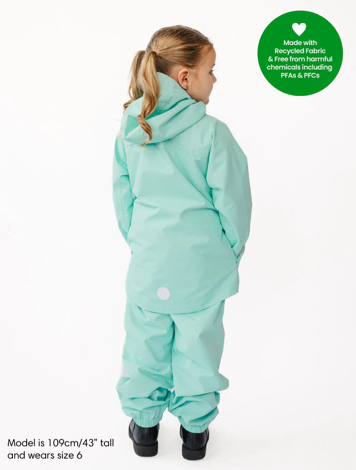 Child wearing a light blue snowsuit on a white background with a green label indicating recycled fabric.