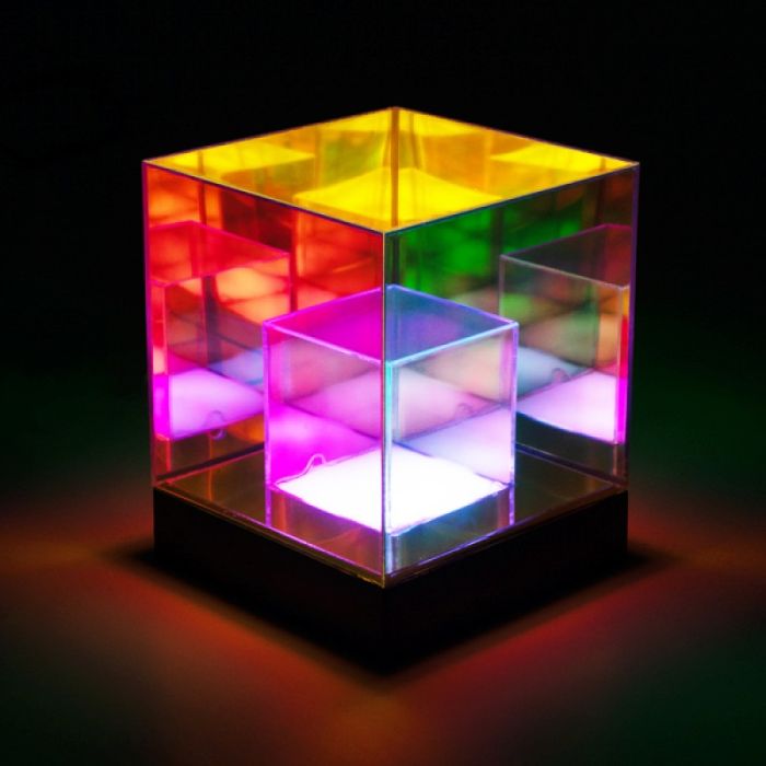 Multicolored transparent cube with light effects on a dark background