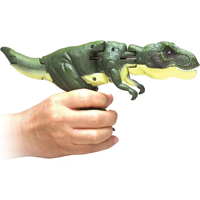 green tyrannosaurus toy being held by its legs