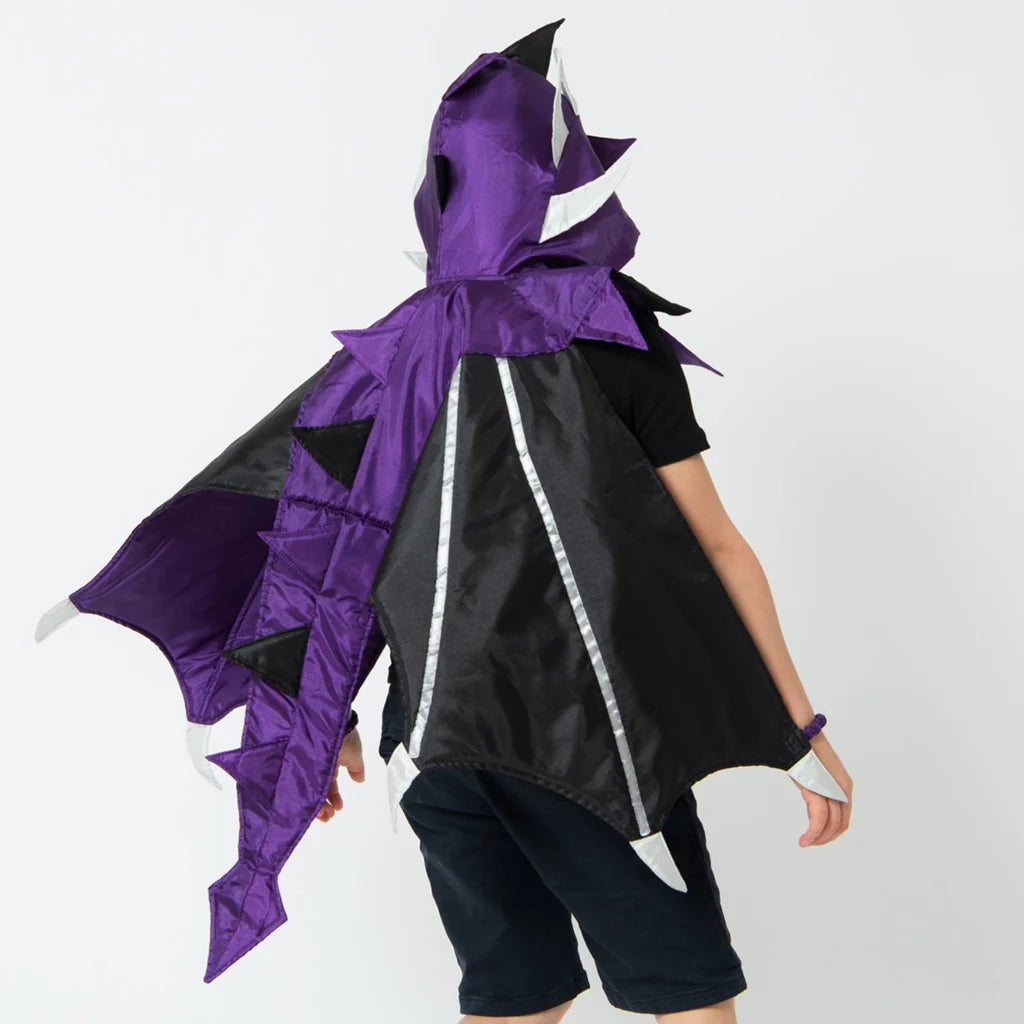 Person wearing a black and purple dragon costume on a white background