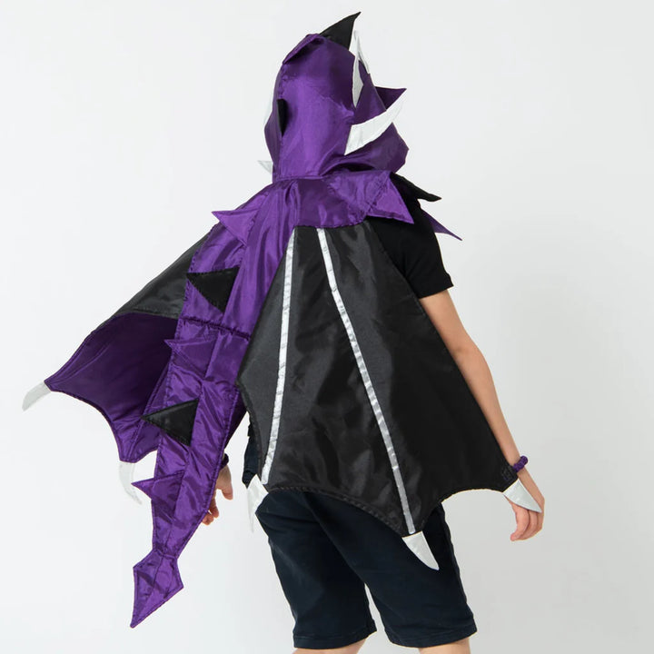 Person wearing a black and purple dragon costume on a white background